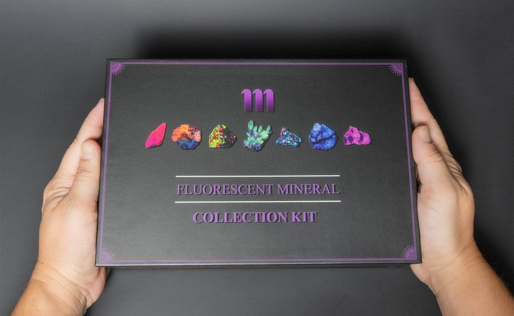 fluorescent mineral collection box showing fluorescent sodalite, green opal, purple fluorite, calcite rhomb, fluorescent ruby