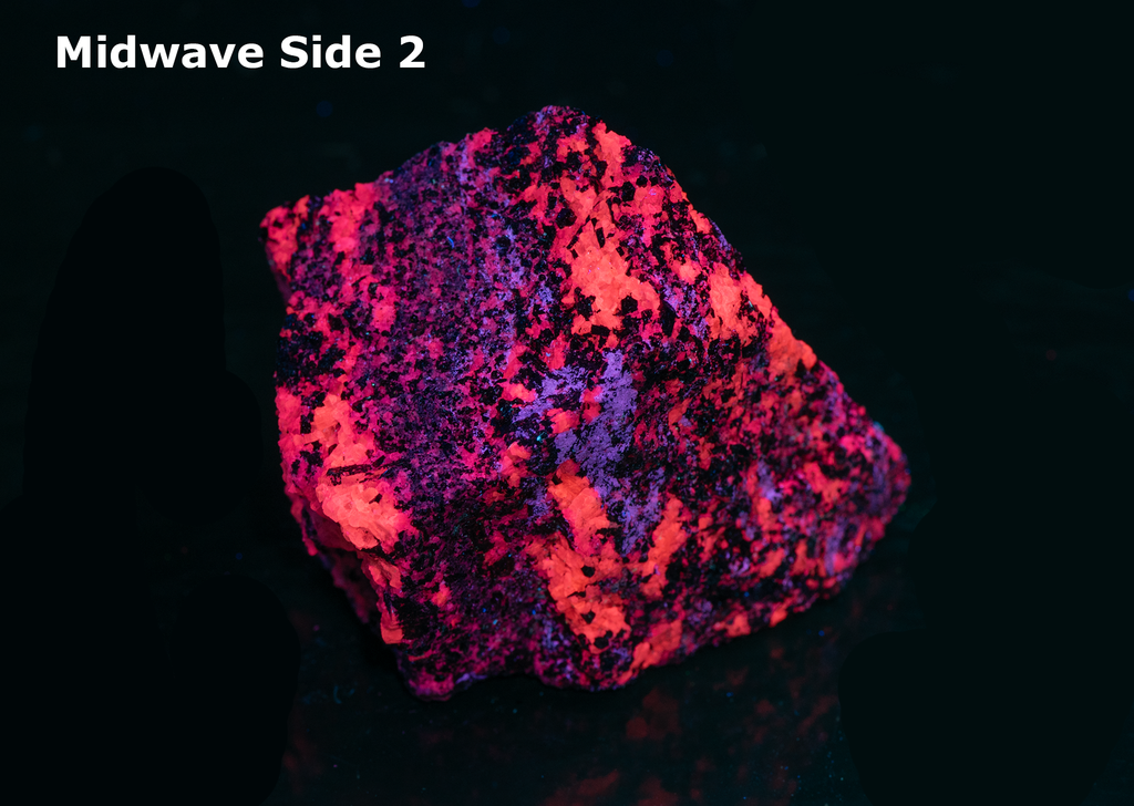 Reddish-brown pyrochlore crystals throughout a white calcite matrix