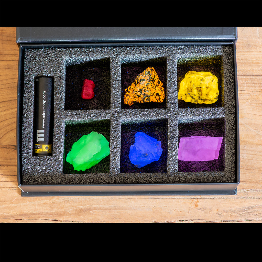 Fluorescent Mineral Collection Kit with fluorescent sodalite, ruby, green opal and pink calcite. It also comes with a UV flashlight.